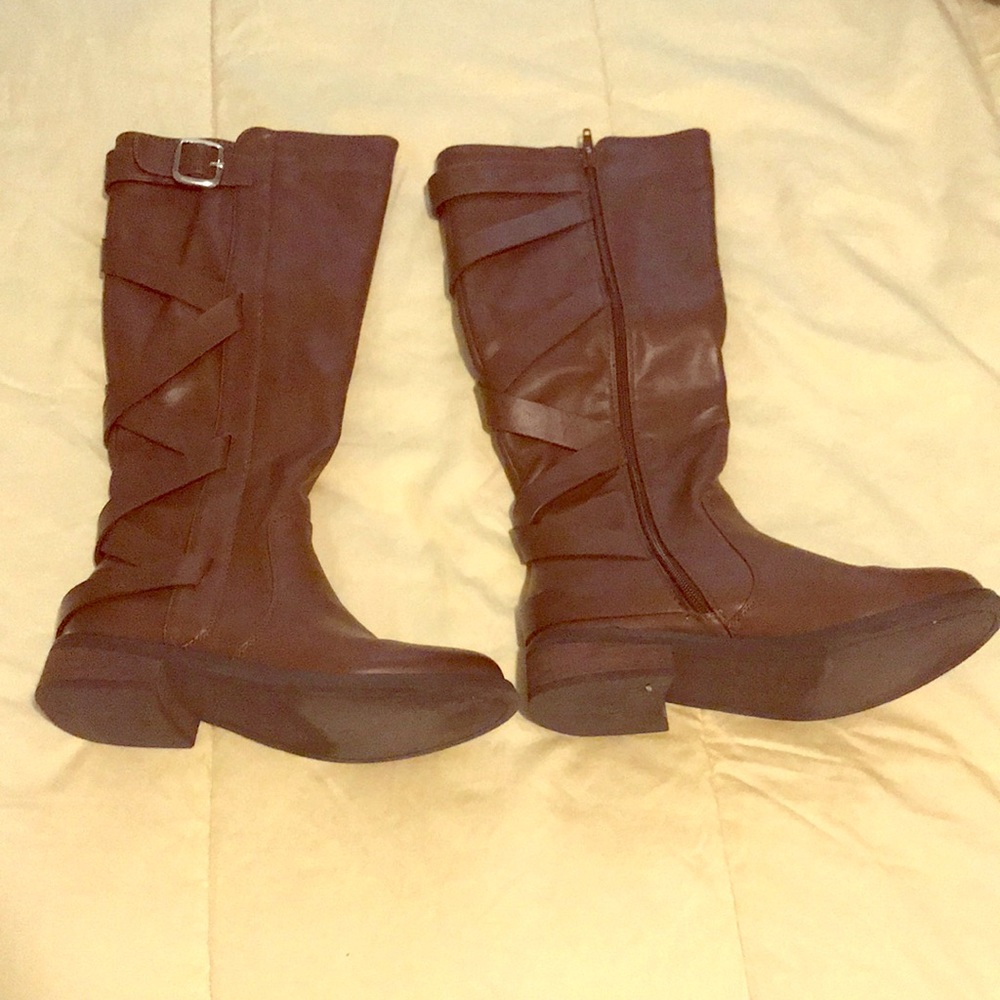 Brown boots with cross cross and buckle detail